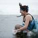 A member of the Ice Ice Baby team jumps into Ford Lake on Saturday, Feb. 16. Daniel Brenner I AnnArbor.com